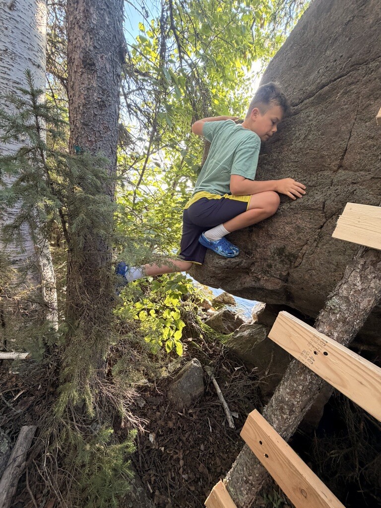 Birch climbing the big rock near Beach One