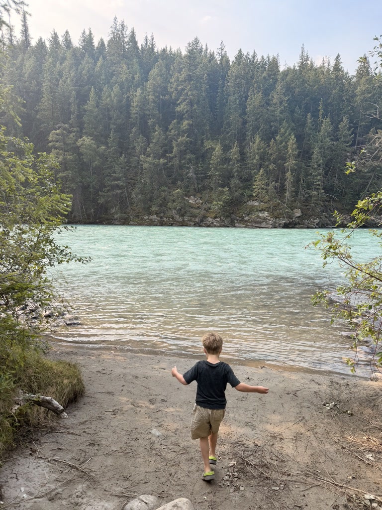 Douglas walking down to the turquoise Fraser River
