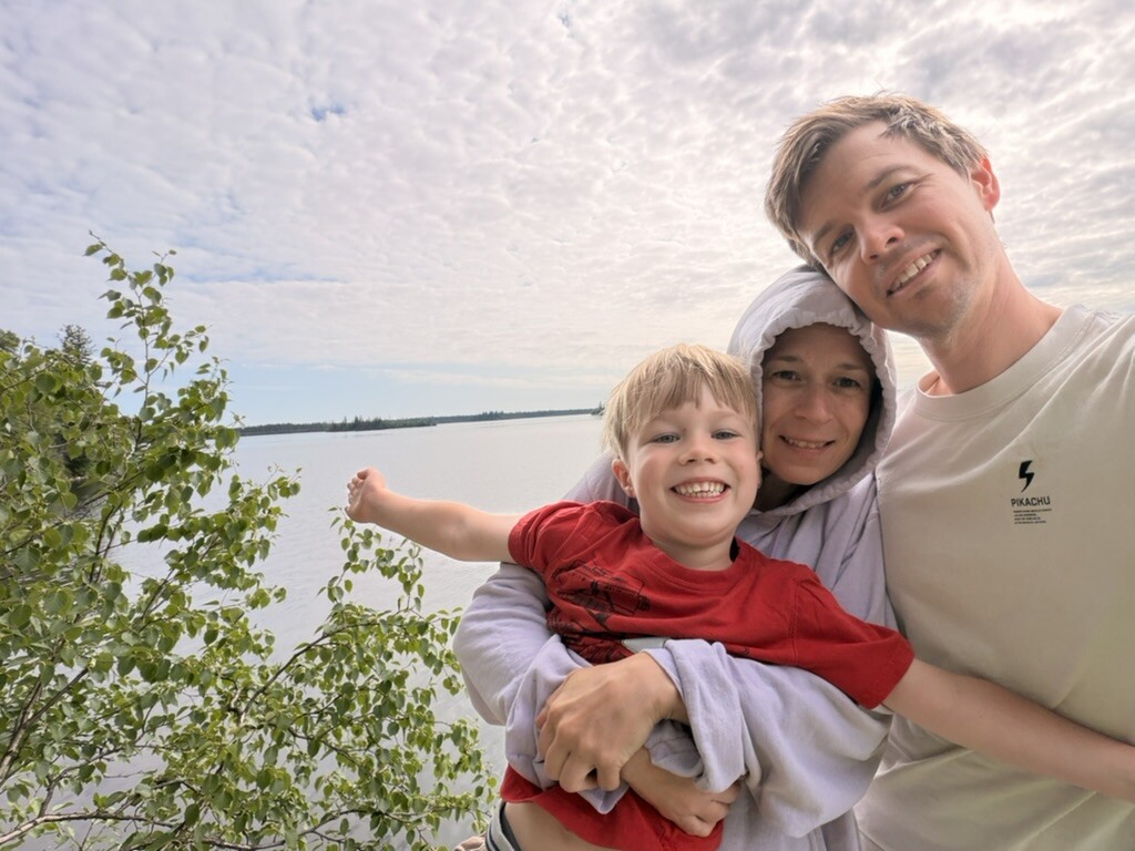 Family selfie beneath the trees beside Besnard Lake