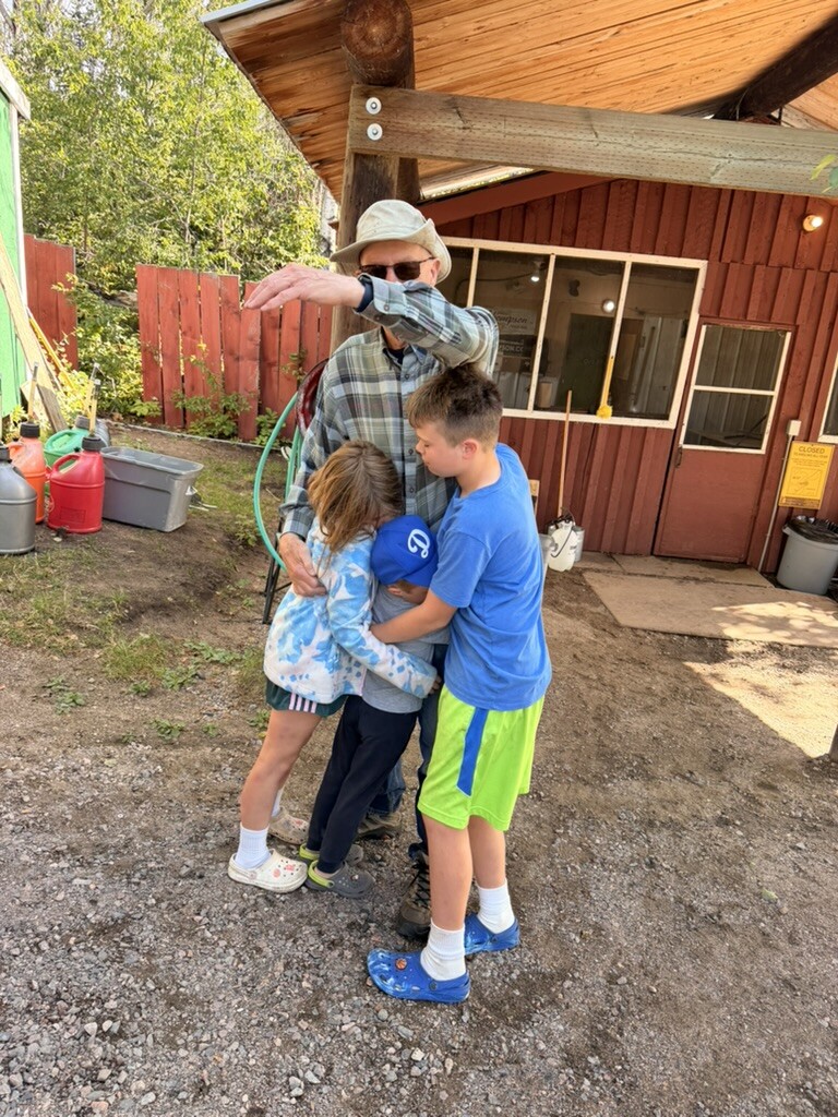A goodbye hug outside the cabin