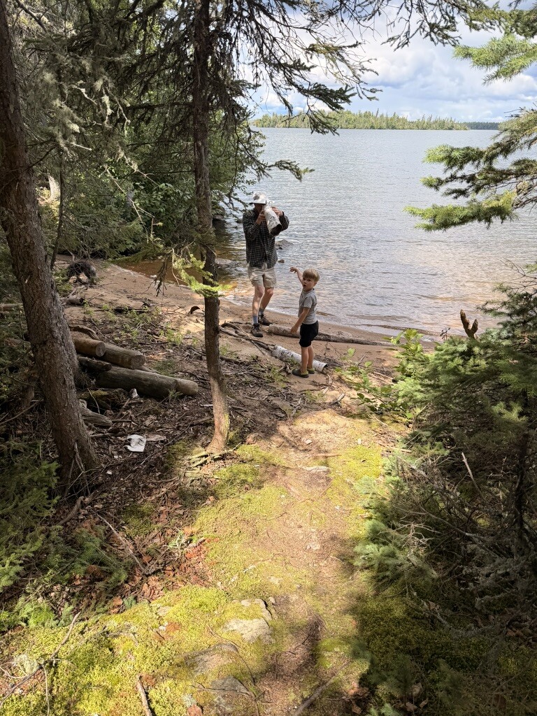 Grandpa holding up a piece of birch bark with a hole in it