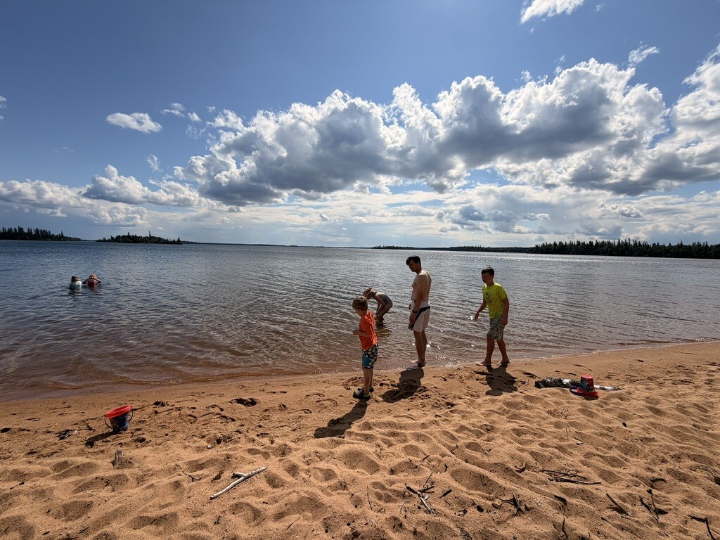 Children playing across the wide sandy shore at Long Beach