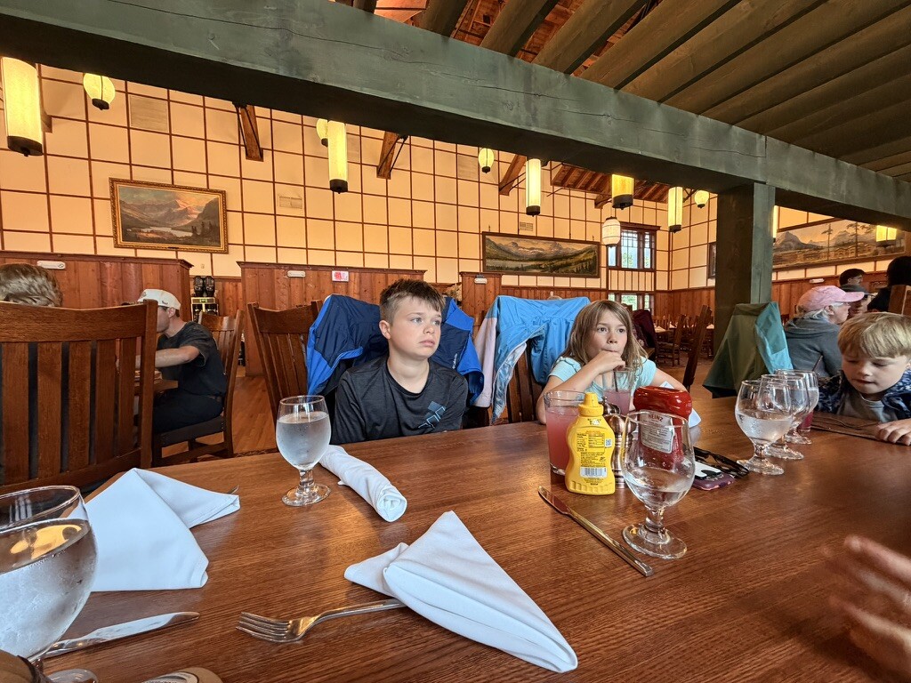 Family seated for lunch in the Many Glacier dining room