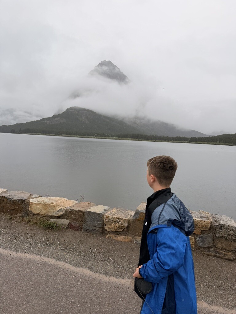 Many Glacier lake and mountains disappearing into low clouds