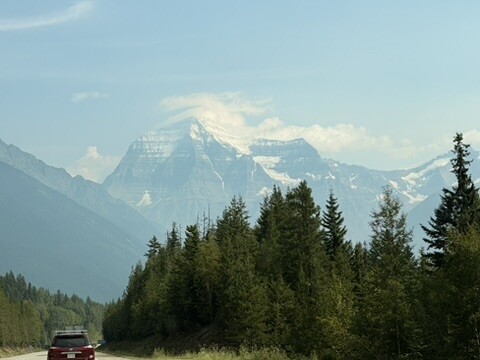 Mount Robson above the trees beside the highway