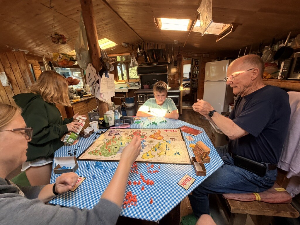 Family gathered around the table for a long game of Risk