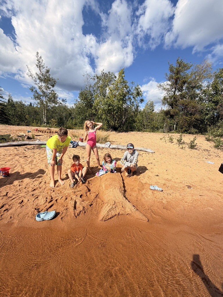 Children building together in the sand at Long Beach