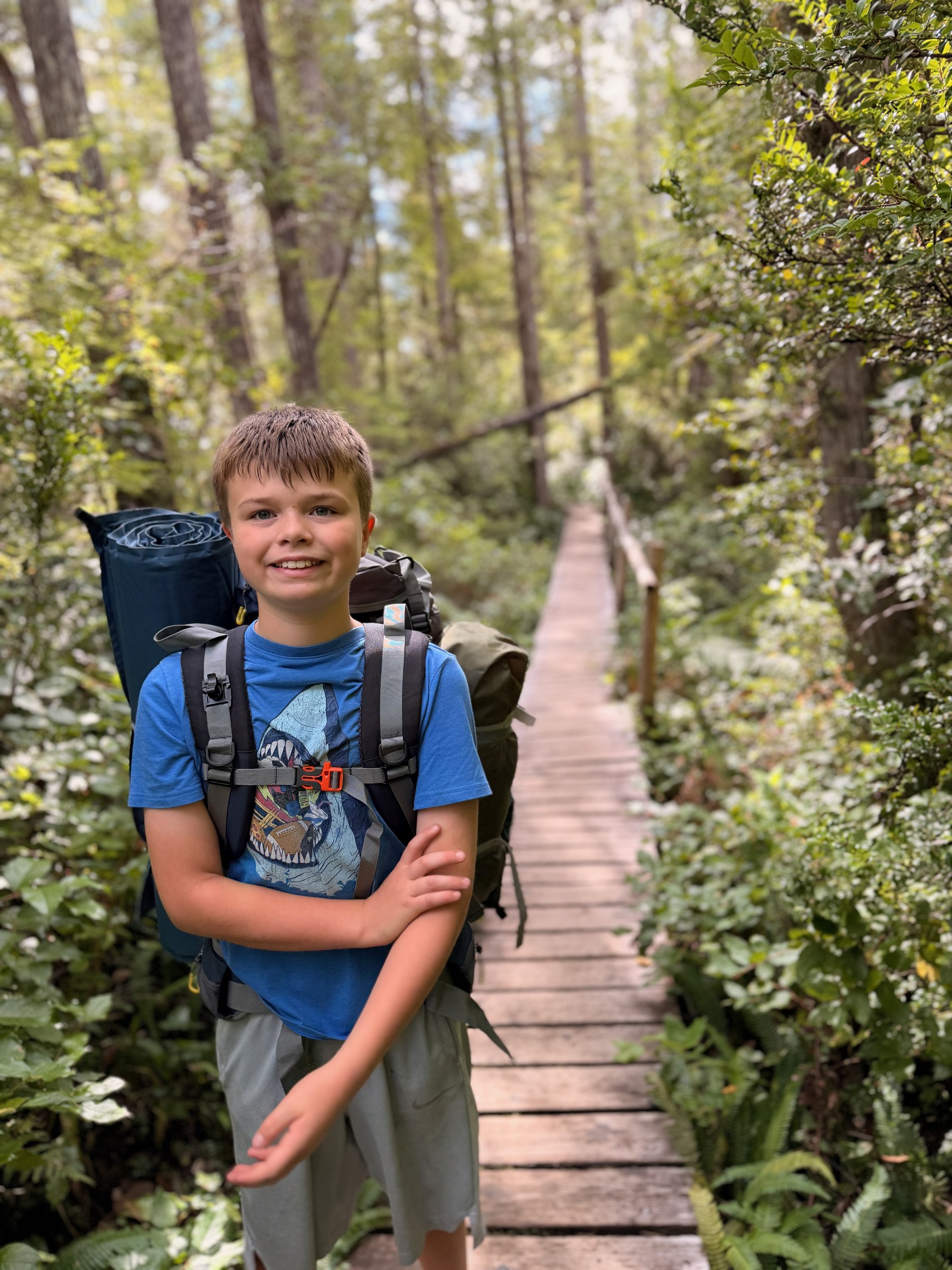 Birch smiling on the Ozette boardwalk with his backpack
