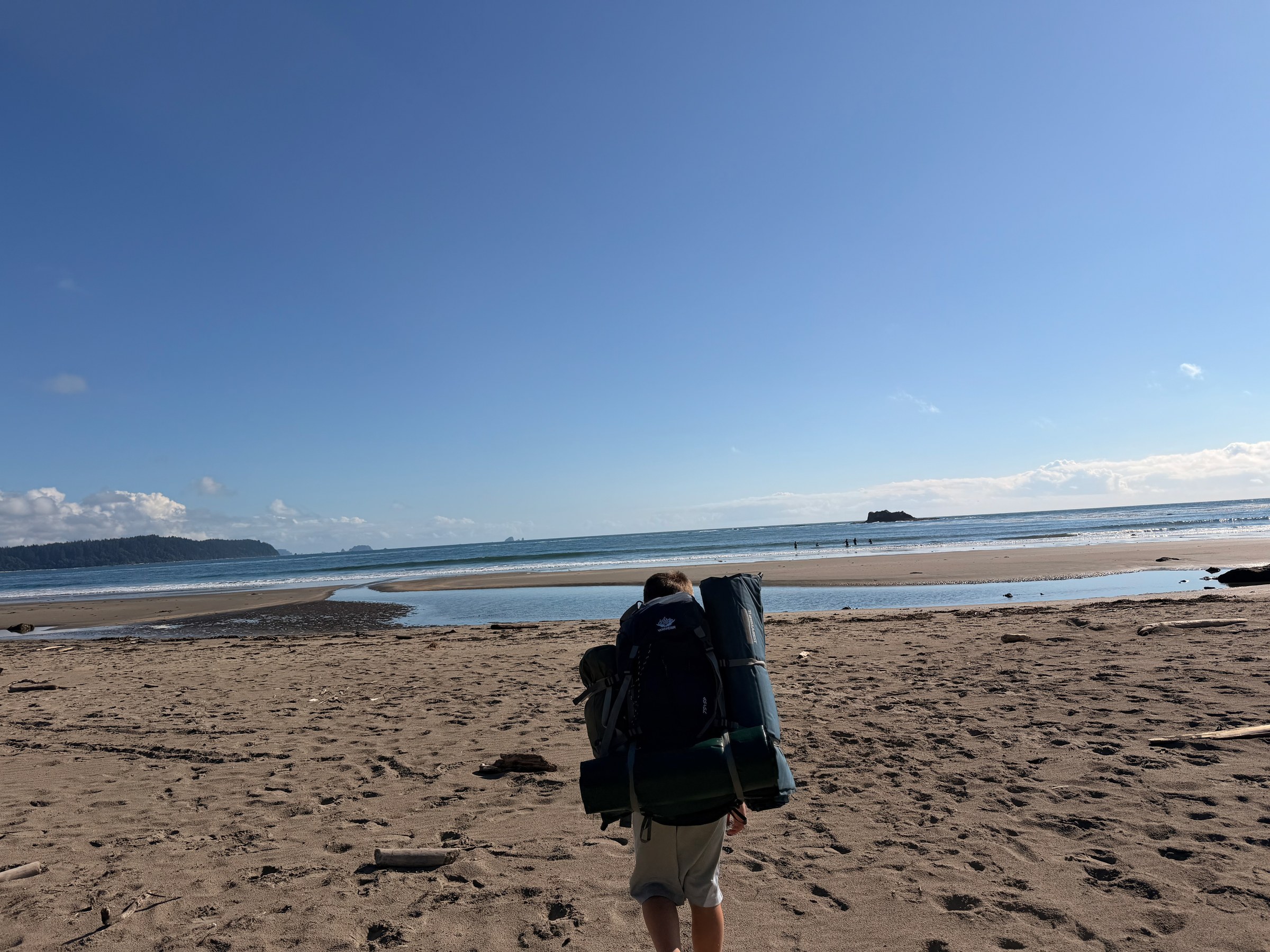 Birch arriving at the Pacific Ocean with his backpack