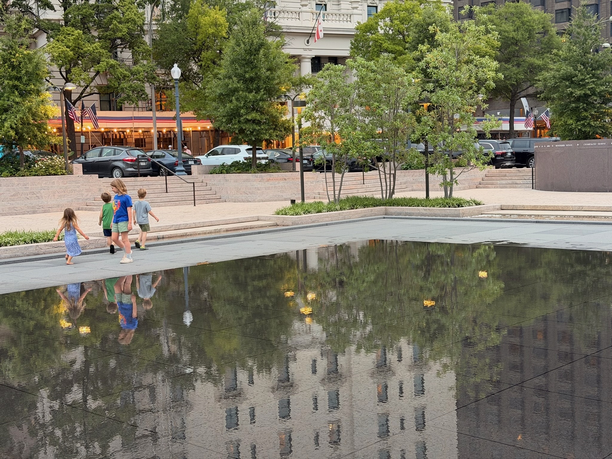 Children reflected in the water at Freedom Plaza