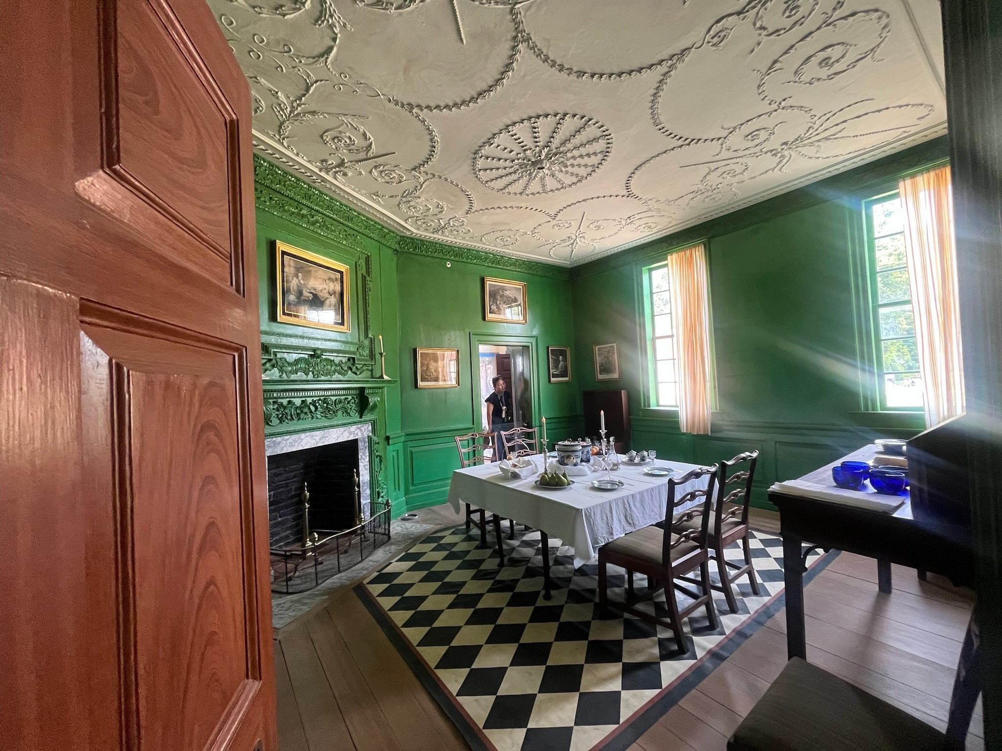 The family touring the green dining room inside Mount Vernon
