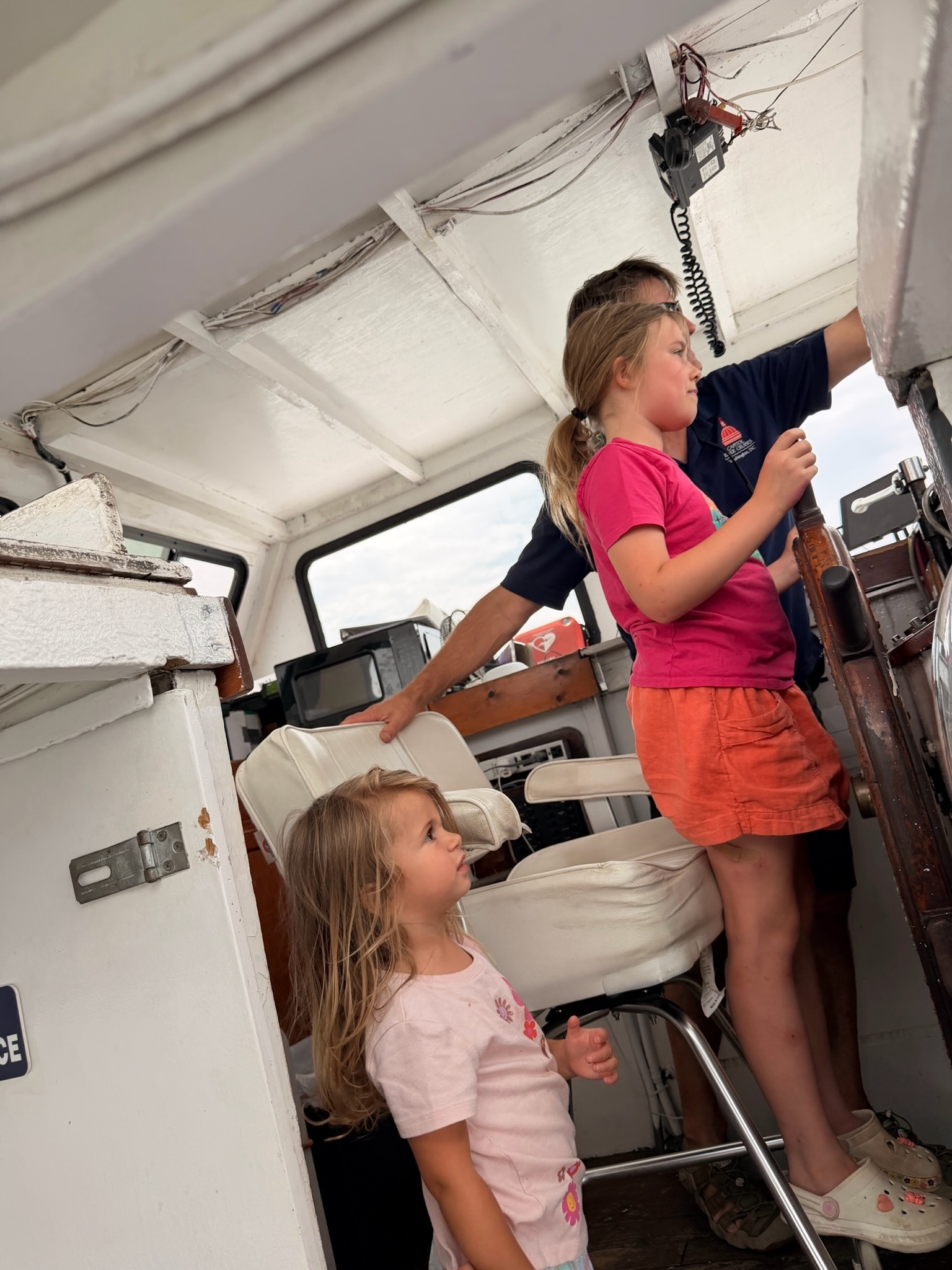 A child taking a turn steering the sightseeing boat